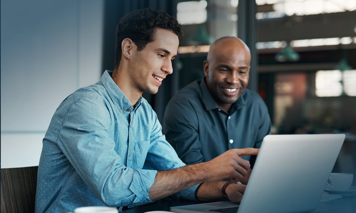 two men collaborating while looking at laptop